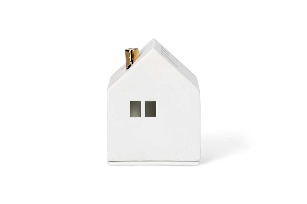 Maison lumineuse cheminée dorée Räder porcelaine blanche
