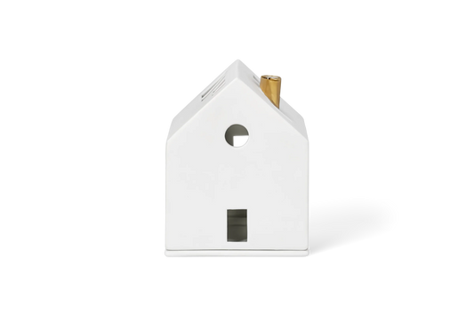 Maison lumineuse cheminée dorée Räder porcelaine blanche