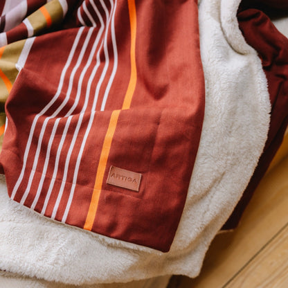 Plaid biface Artiga Sarron - rayures colorées sur fond rouge profond